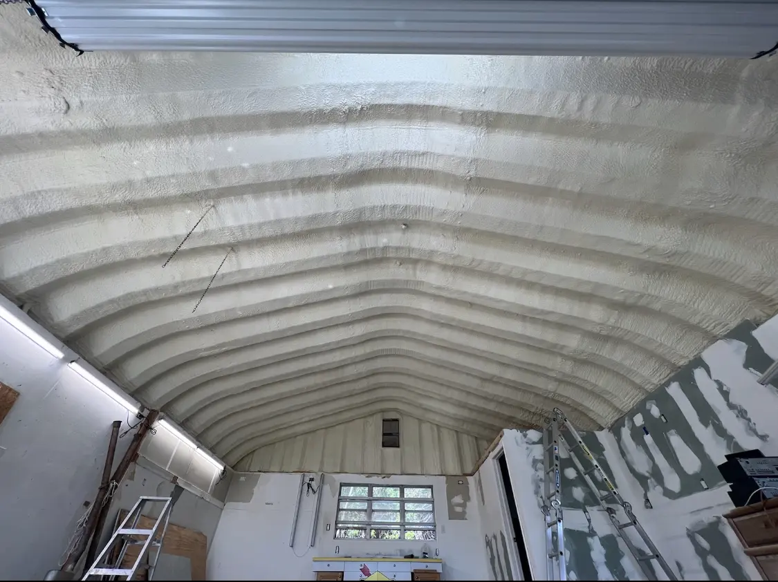 Spray polyurethane foam applied to the underside of a metal roof deck in Graham